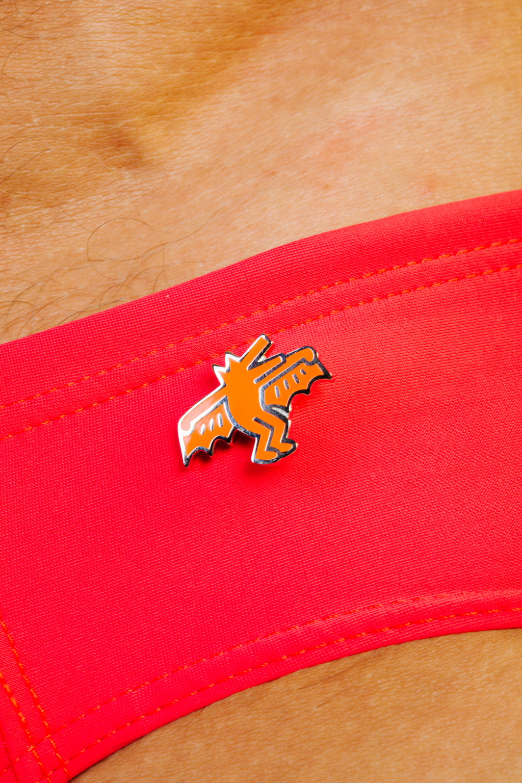 KEITH HARING BAT DOG PIN - ORANGE