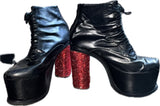 Lot 9: Syro black leather high heel platforms customized with red rhinestones hand done by Adam Lambert