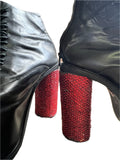 Lot 9: Syro black leather high heel platforms customized with red rhinestones hand done by Adam Lambert