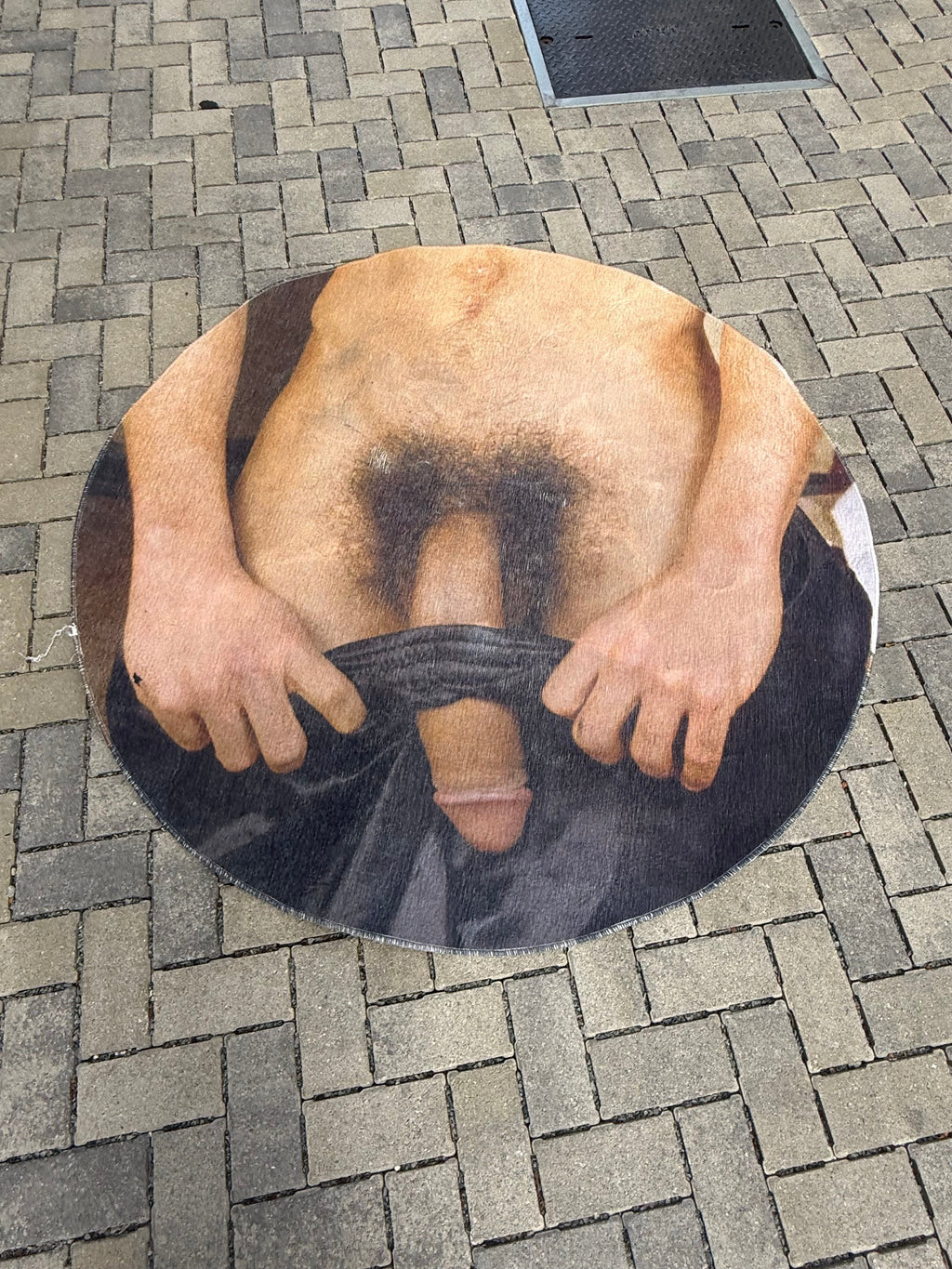 Round printed woven rug with artwork by Chuck, full view