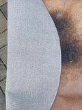 Edge turned back to show the grey woven backing
