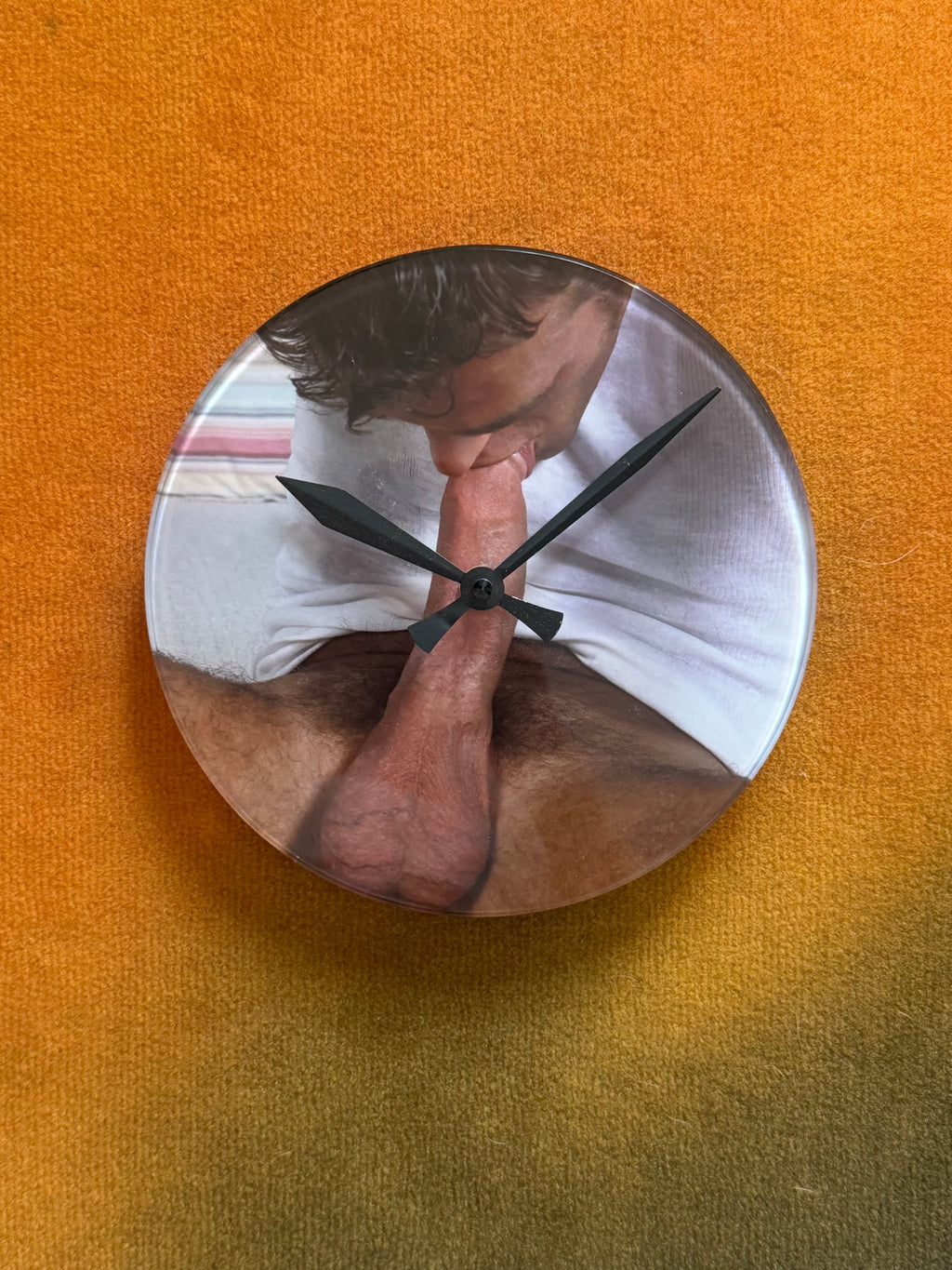 Round wall clock with printed artwork by Chuck on the face, black hands