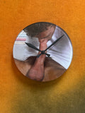 Round wall clock with printed artwork by Chuck on the face, black hands
