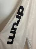 Detail of the left sleeve printed with the word drum in heavy lowercase letters