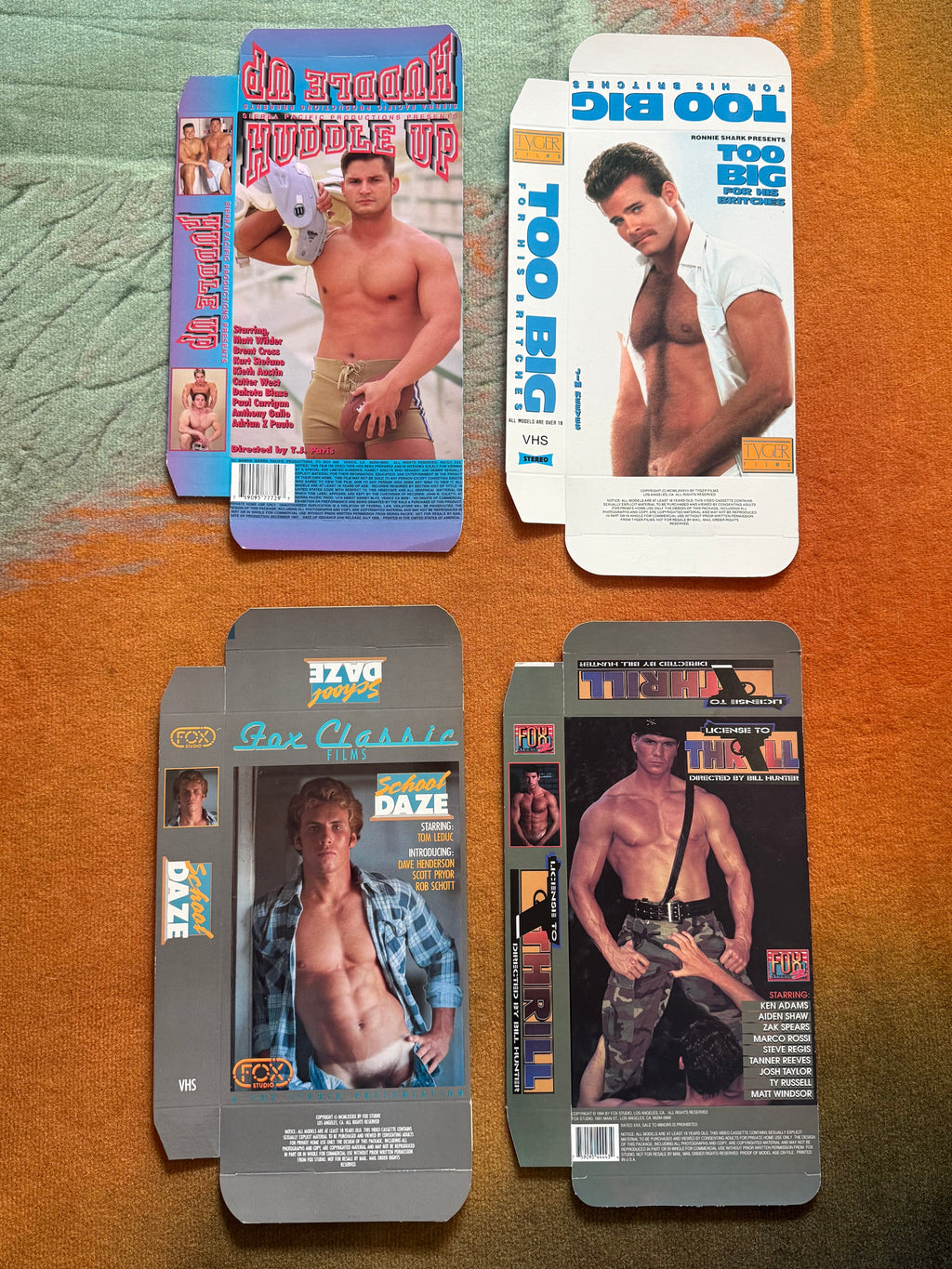 Four flattened vintage VHS sleeves including Too Big For His Britches and School Daze