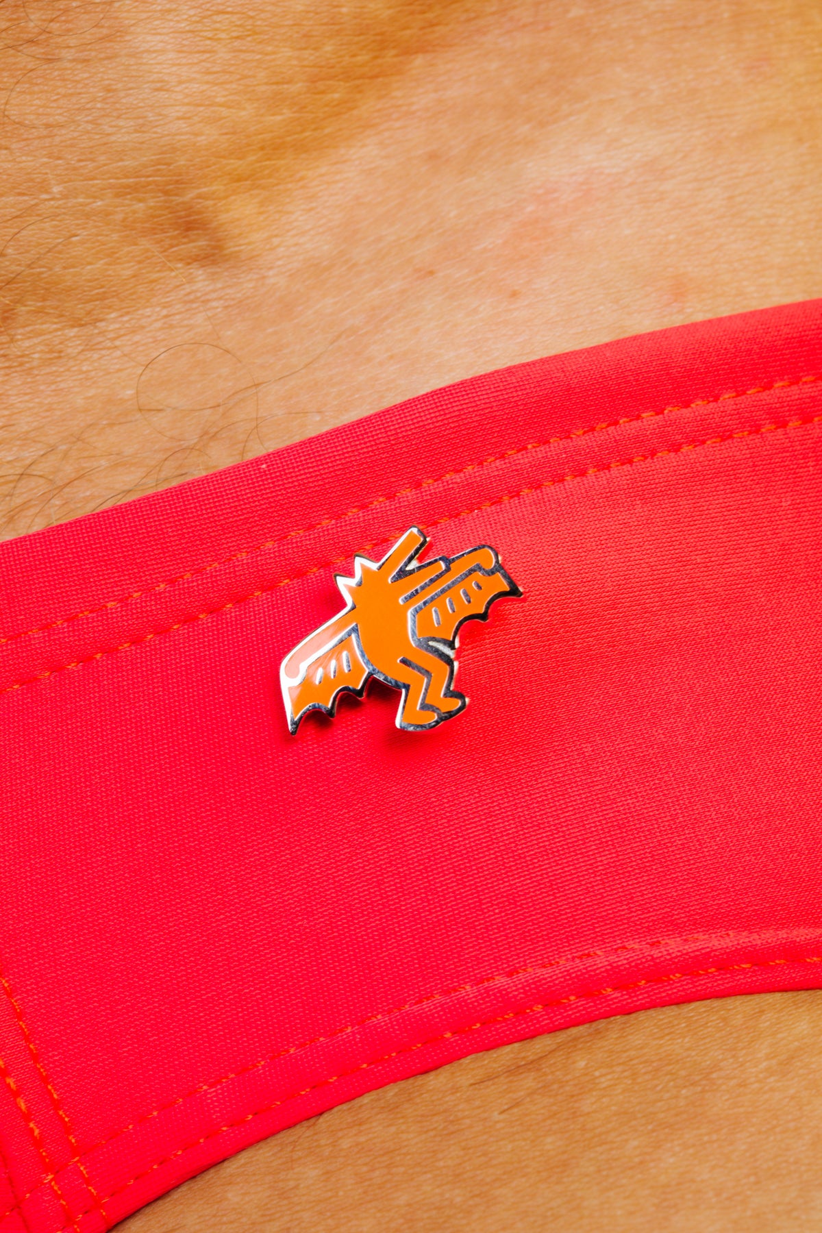 KEITH HARING BAT DOG PIN - ORANGE